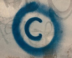 Large copyright graffiti sign on cream colored wall