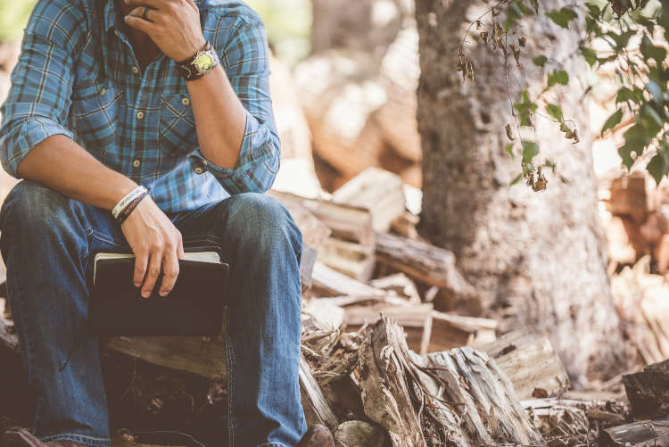 Man reflecting in woods